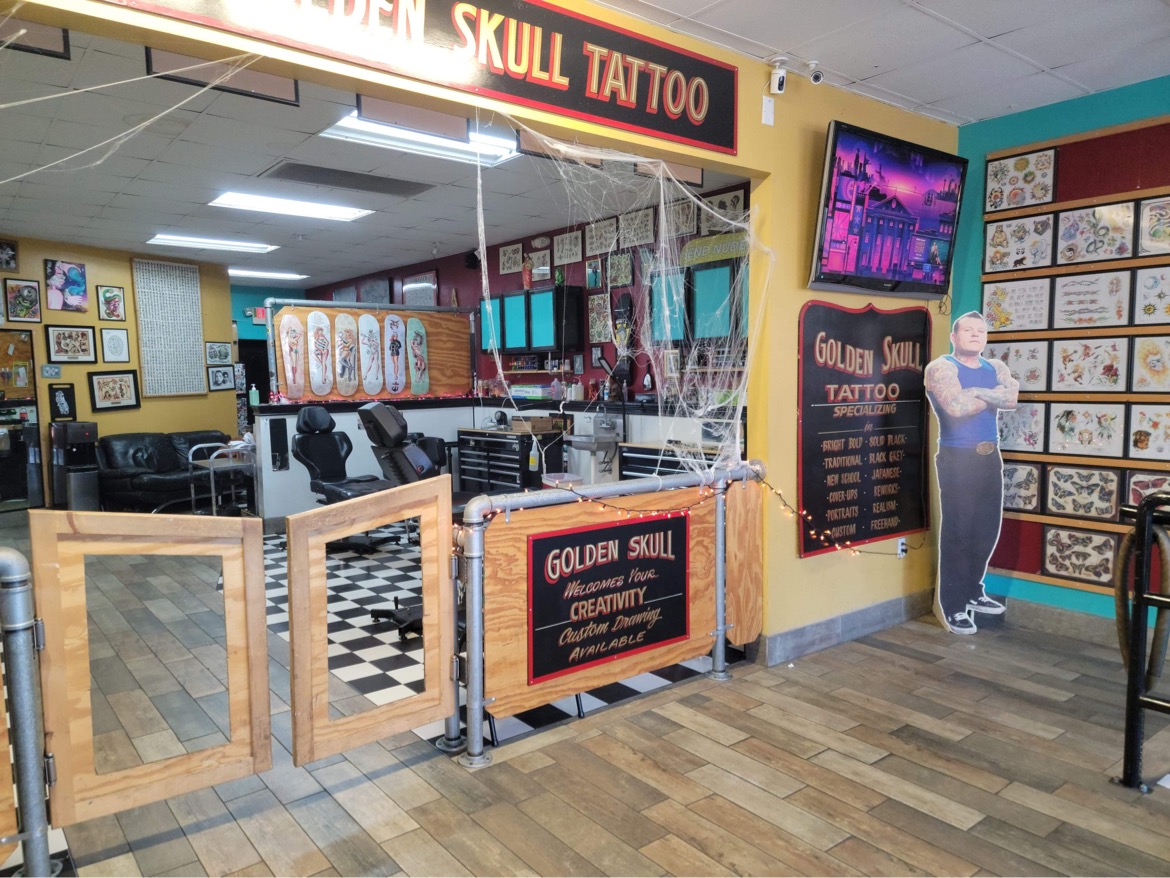 Golden Skull Tattoo studio interior with flash art walls